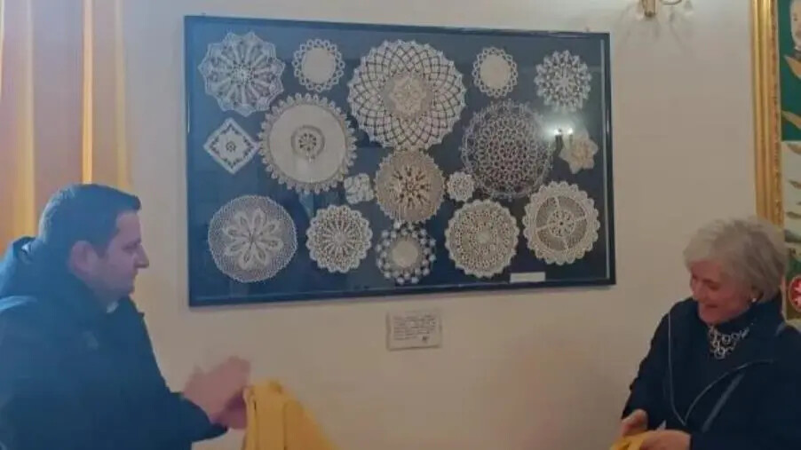 images Taverna festeggia la donna con un quadro realizzato all'uncinetto dalle donne del paese